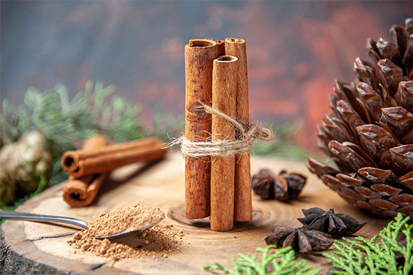 a couple of cinnamon sticks sitting on top of a wooden table.