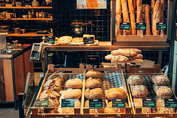 a bakery filled with lots of different types of bread.