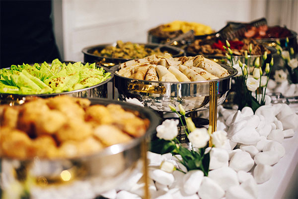 a buffet table filled with lots of different types of food.