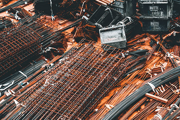 a pile of steel bars sitting on top of a pile of other metal bars.