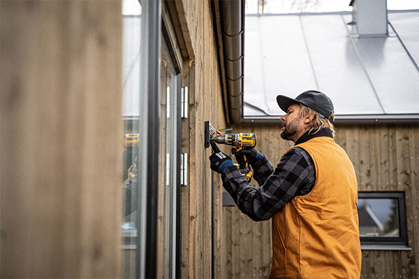 a man with a driller and a hat on.