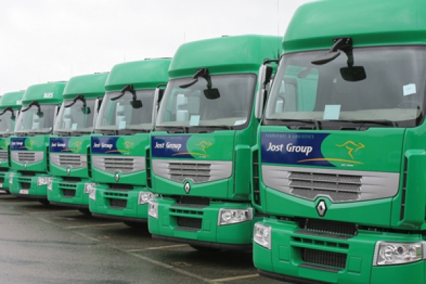 a row of green trucks parked next to each other.