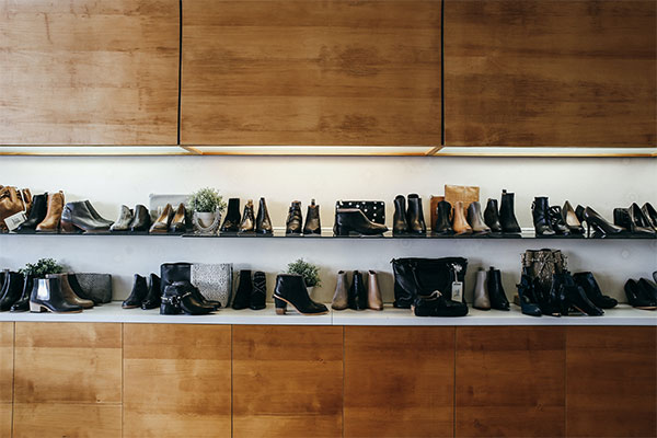 a shelf filled with lots of different types of shoes.