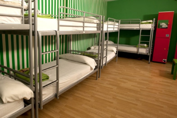 a room with a bunch of bunk beds in it.