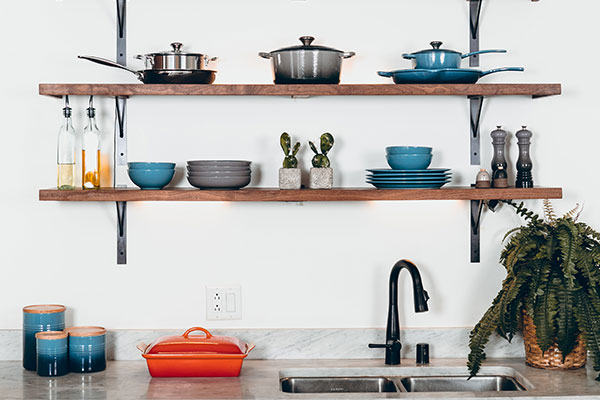 a kitchen counter with pots and pans on it.