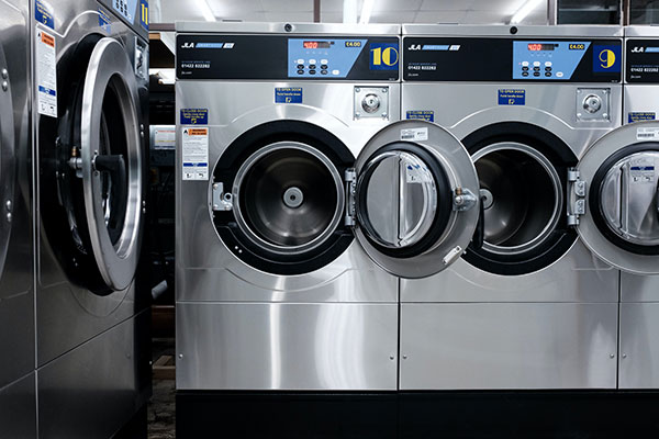 a row of washing machines sitting next to each other.