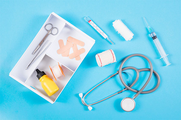 a medical kit with a stethoscope, pills, and other medical supplies.