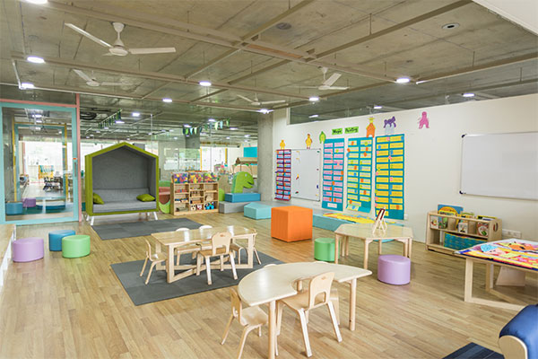 a child's playroom with a play table and chairs.