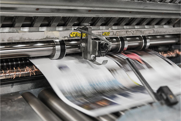 a machine that is printing a large sheet of paper.