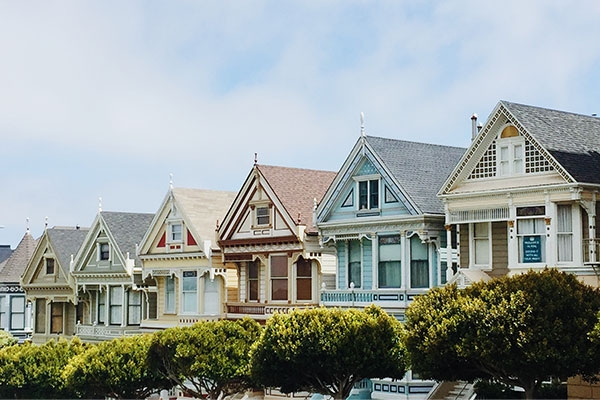 a row of houses with a row of lawn chairs in front of them.