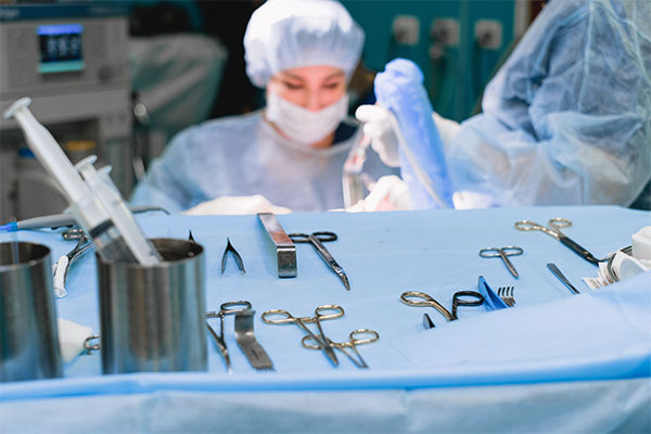 a surgeon is performing surgery on a patient.