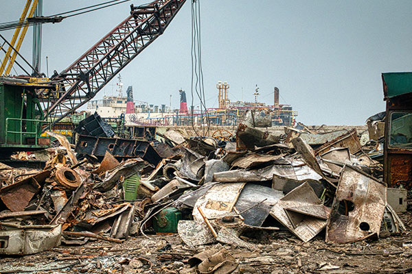 a pile of junk with a crane in the background.
