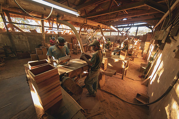 a group of men working in a wood shop.